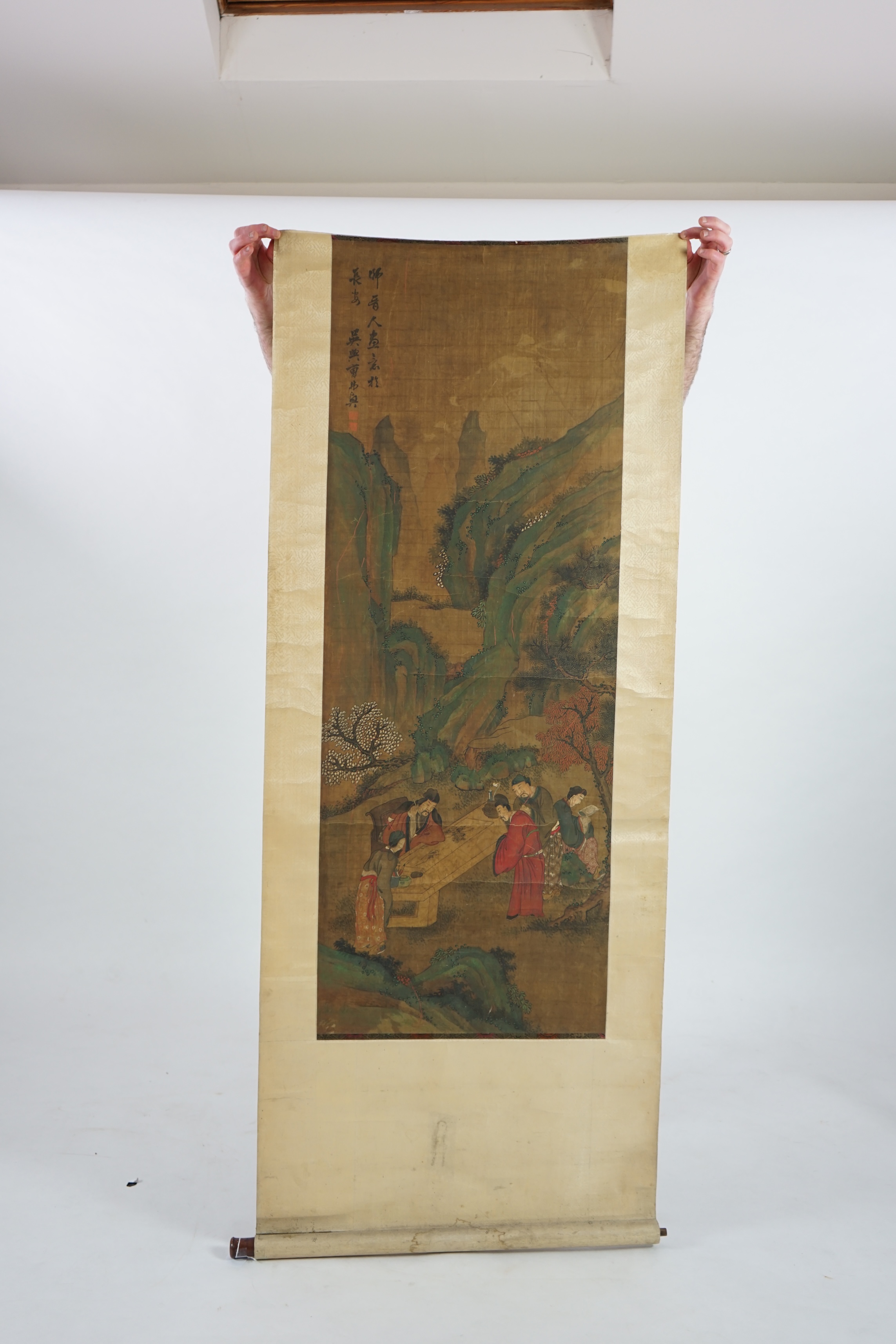 Chinese School, 19th century, scroll painting, ink and colour on silk, scholars in a garden examining a painting